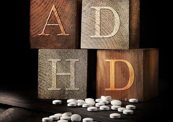 Picture showing wooden blocks with the letters ADHD and tablets below