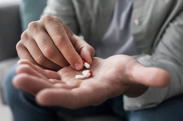 Picture showing a hand holding antidepressants for treatment of depression in Dubai