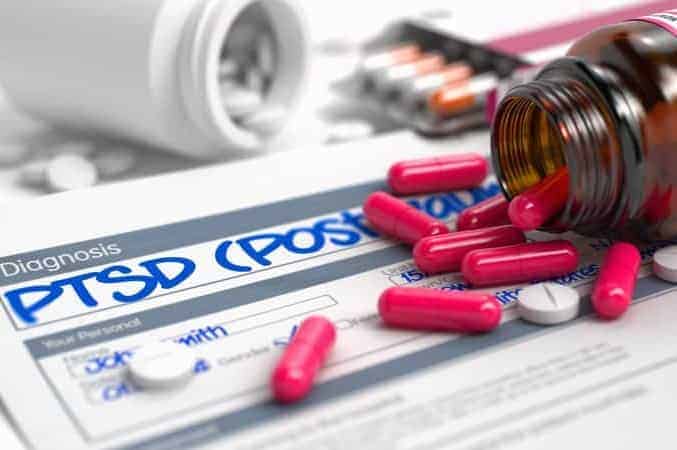Treatment for PTSD in Dubai. Medication treatment for PTSD. The picture shows tablets used in the PTSD treatment. It shows an open bottle with a few capsules lying on a piece of paper with the inscription "PTSD." The picture relates to treatment for PTSD
