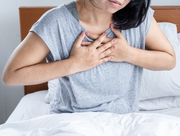 Panic Attacks in Dubai. FAQ. The picture shows a women holding her crossed a hands on the chest during a panic attack